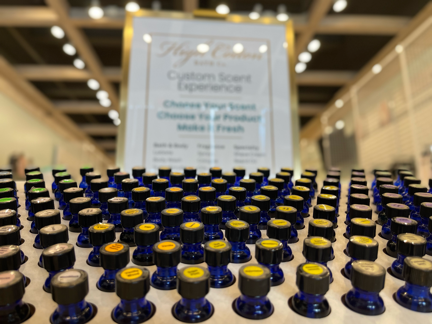 Blue fragrance bottles arranged across the High Cotton Scent Table.